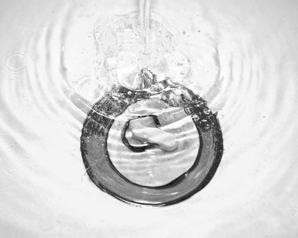 Water swirling down a sink drain Water swirling down a sink drain