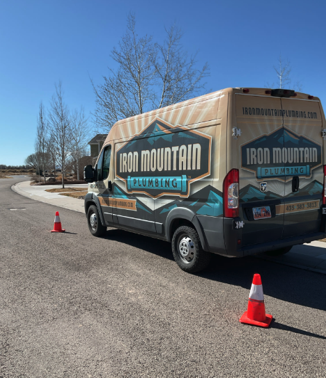 Iron Plumbing van headed for drain cleaning Cedar City