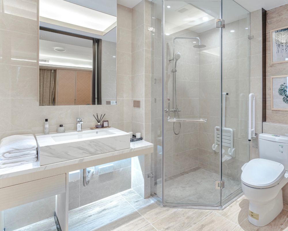 Modern bathroom with a glass shower and marble sink.