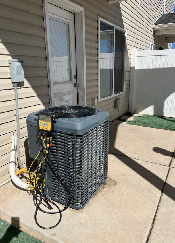 grey AC unit outside after HVAC repair Cedar City