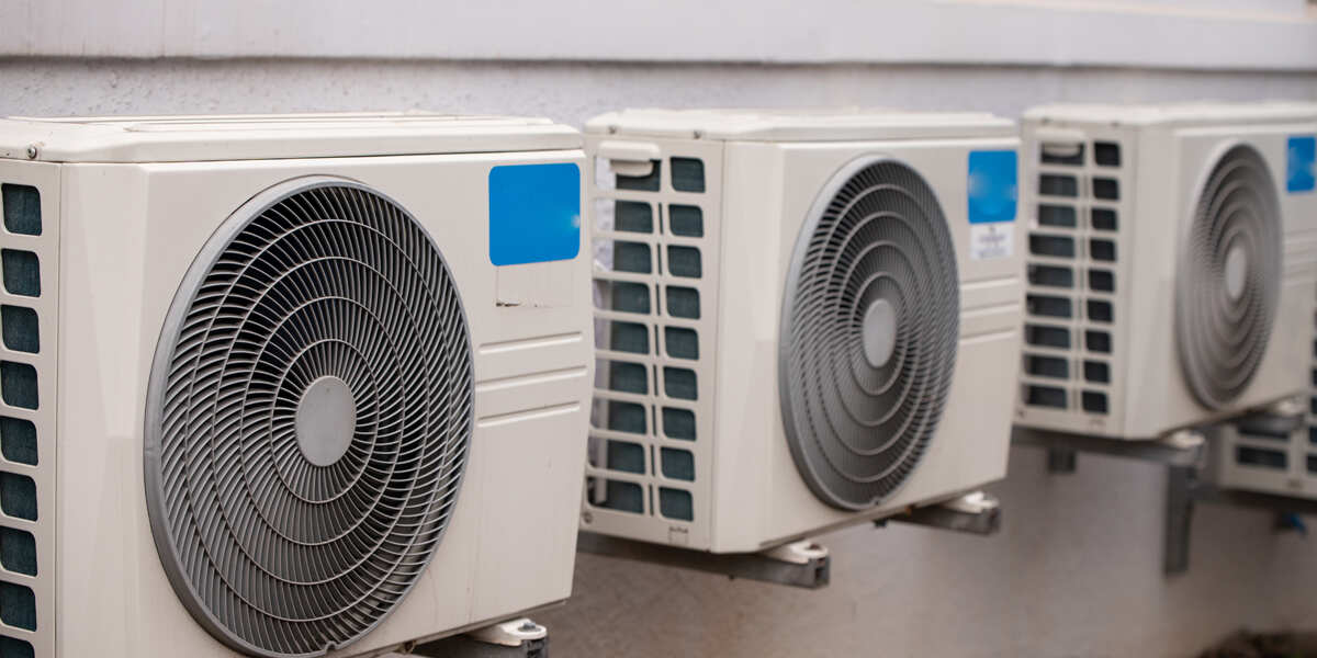 Outdoor air conditioning units mounted on a wall.